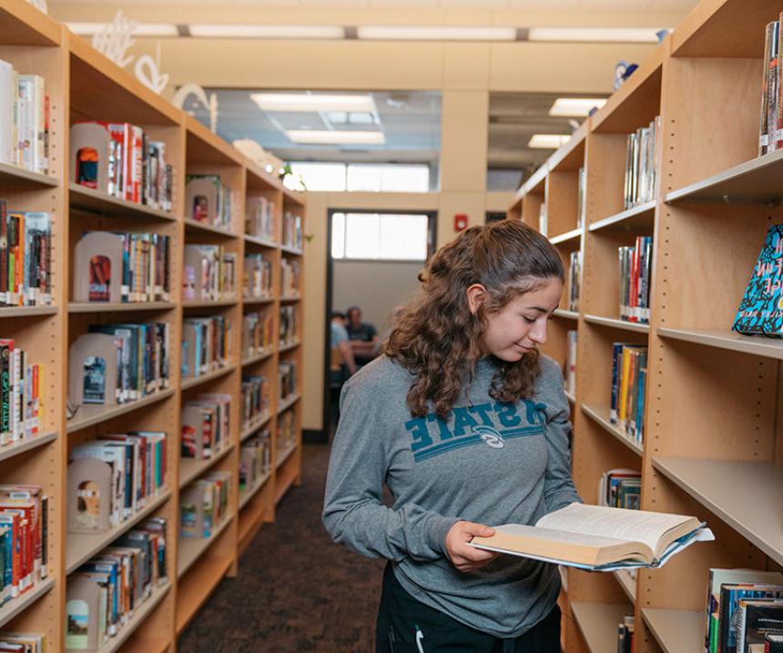 A student examines a book at the library