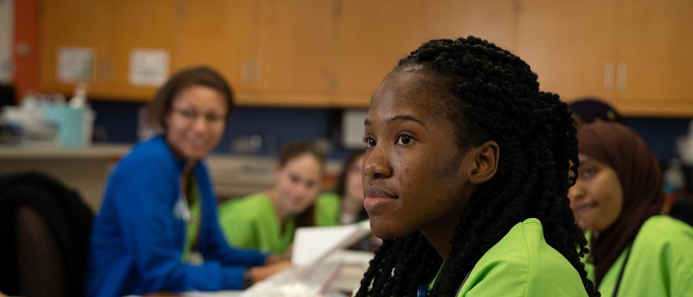 A student thoughtfully listens in class